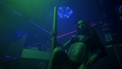 a woman holding a pole in a dark room