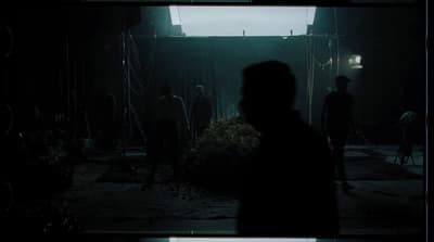 a group of people standing in a dark room