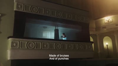 a man standing in a room with a punching bag