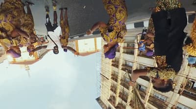 a group of people hanging upside down from a building