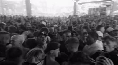 a large group of people standing in front of a stage