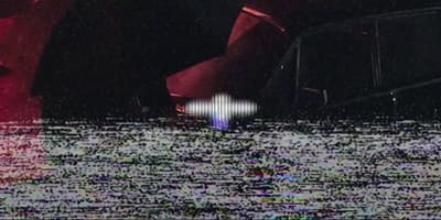 a blurry image of a person walking in the rain