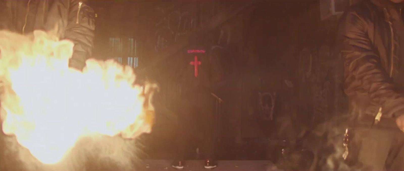 a man standing in front of a large fire