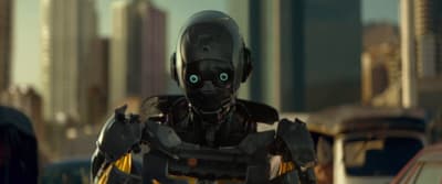 a robot with glowing eyes standing in the middle of a city
