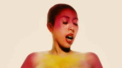 a woman with red and yellow paint on her body