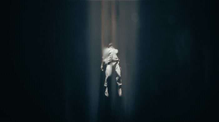 a blurry image of a person standing in a dark room