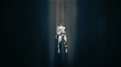 a blurry image of a person standing in a dark room