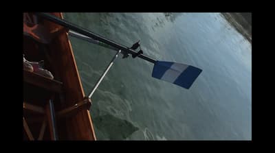 a blue and white flag hanging from the side of a boat
