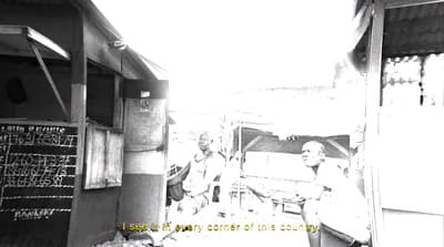 a black and white photo of two men standing in front of a building