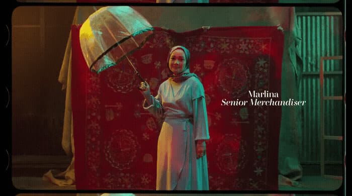 a woman in a white dress holding an umbrella
