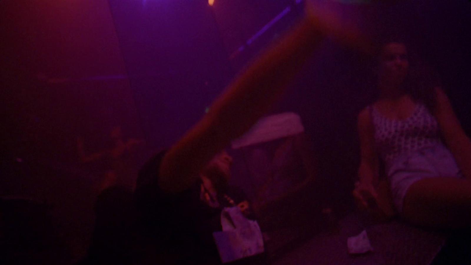 a woman standing in front of a purple light