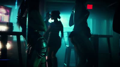 a group of women standing in a dark room