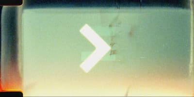 a close up of a street sign with a white arrow
