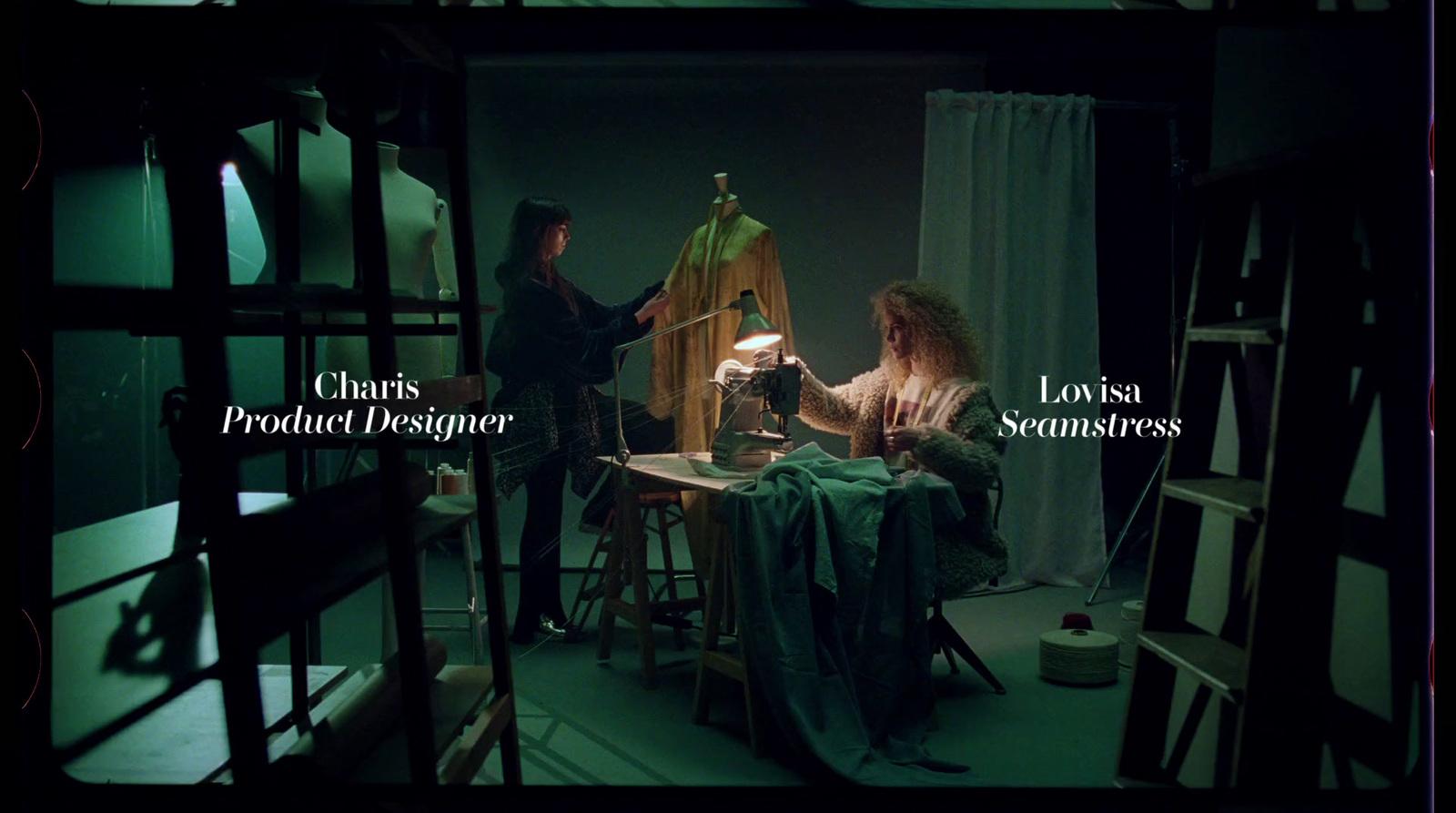 a woman sitting in a chair next to a lamp
