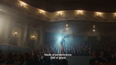 a person standing on a stage in front of a crowd