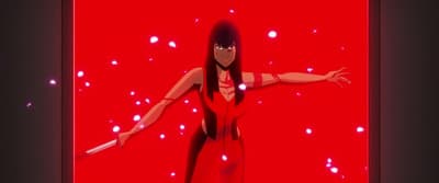 a woman in a red dress standing in front of a red background
