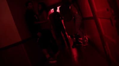 a group of people standing in a dark room