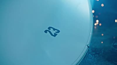 a close up of a white object with a blue background