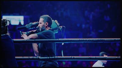 a man with a microphone in a ring