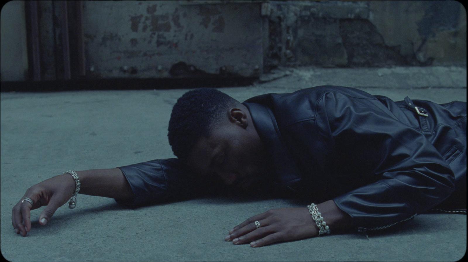 a man laying on the ground with his head down