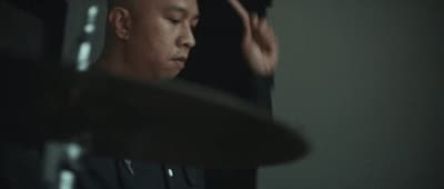 a man in a black shirt holding his hands up
