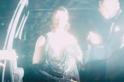 a man and a woman standing in a car