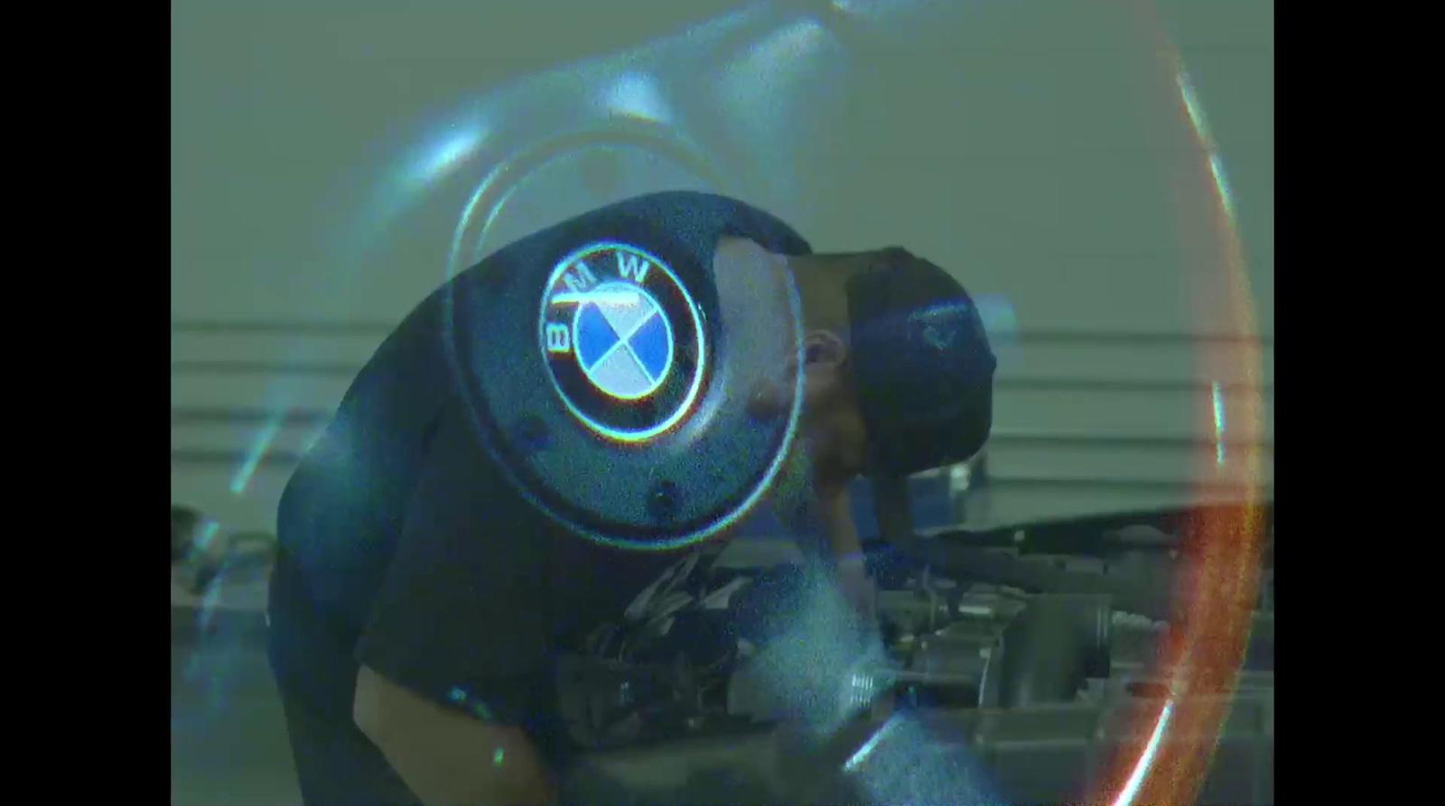 a man working on a car engine in a garage