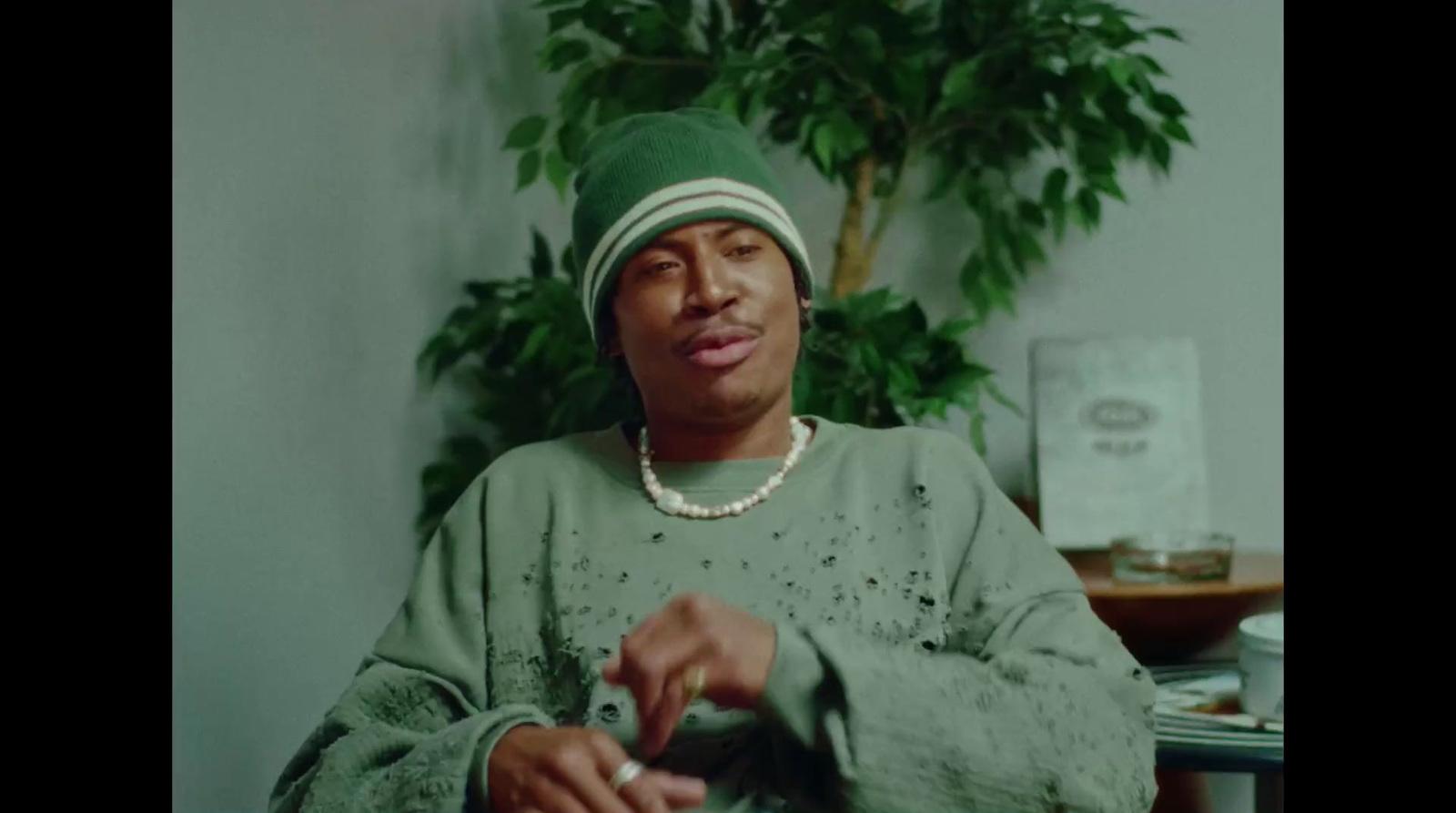 a man in a green shirt and a green hat