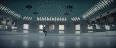 a person standing in a large room with windows