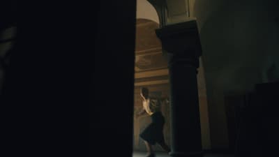 a person standing in a room with a clock on the wall