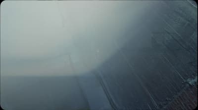 a blurry photo of a street sign on a foggy day