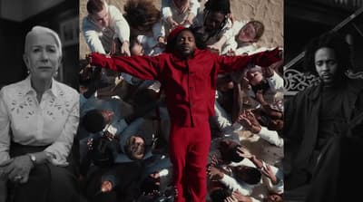 a man in a red suit standing in front of a group of people