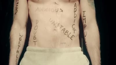 a man with many tattoos on his chest