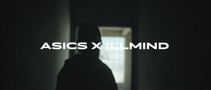 a person standing in a dark hallway with the words asicsxlimind over