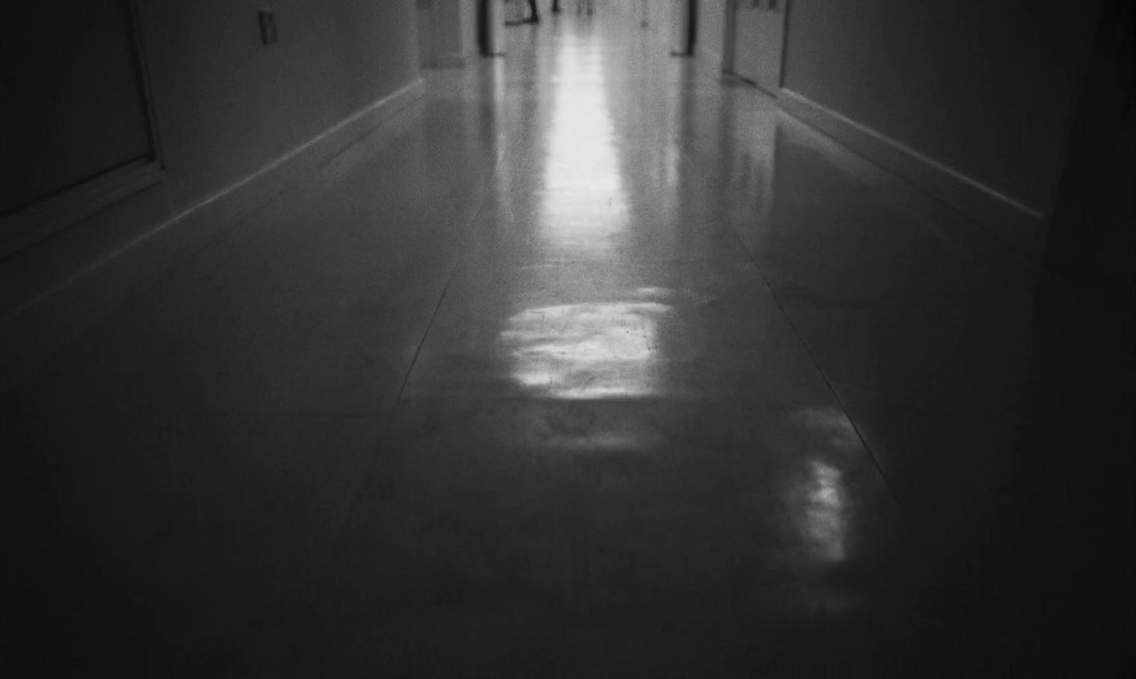 a long hallway with a clock on the wall