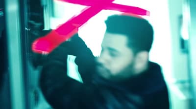 a man is holding a pink letter in front of his face