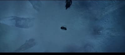 a group of people standing on top of snow covered ground