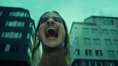 a man with his mouth open in front of a building
