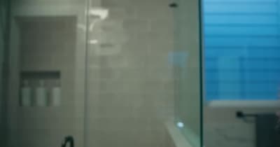 a person taking a selfie in a bathroom mirror