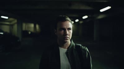 a man is standing in a dark tunnel