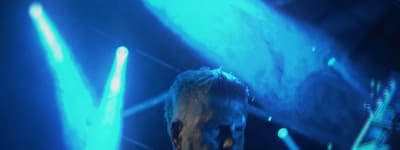 a man standing in front of a blue light