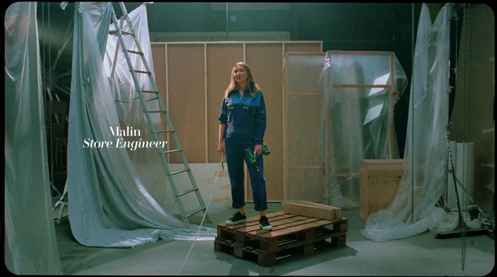 a woman standing in a room with a ladder