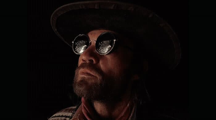 a man with a hat and glasses on