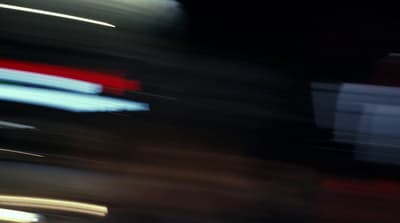 a blurry photo of a traffic light at night