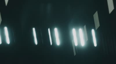 a dark room with a lot of light coming through the windows