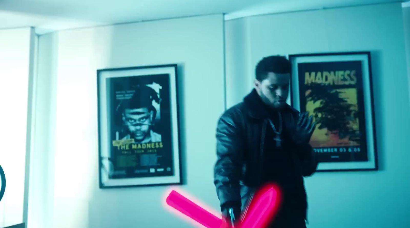 a man holding a neon pink object in his hand