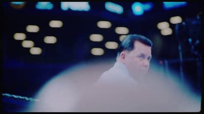 a man in a suit and tie looking at something