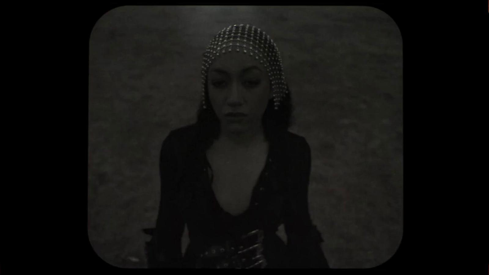 a woman in a black dress and a headpiece