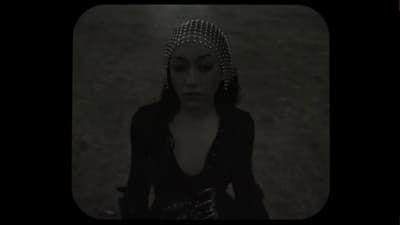 a woman in a black dress and a headpiece