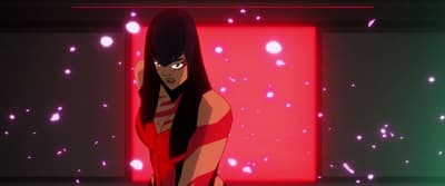 a woman in a red and black dress standing in front of a red and green